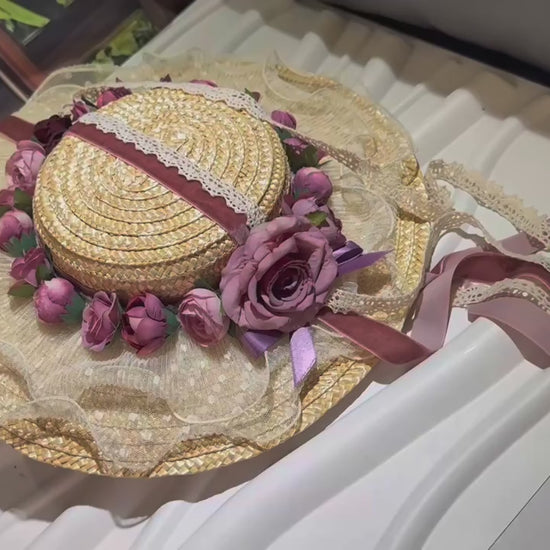 Discover the Amelia, a vintage-inspired straw hat with dusty mauve roses, a lace brim, and velvet ribbons. Perfect for Victorian events, photoshoots, and romantic occasions.